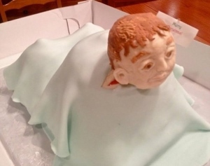 This cake reminds me of that Saint Vincent DePaul statue with the children at my alma mater Saint Vincent College. Let's just say that sculptor didn't know how to draw kids which gave it an aura of creepiness like this cake does. The child in this cake is butt ugly and doesn't seem to resemble a baby at all. Also, it looks too young to be Benjamin Button.