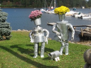 Yes, they have flowers on their heads. Yes, that's a dog made out of cans. And yes, Mrs. Tinman's breasts are cone shaped. Still, it's just a scarecrow display, man.