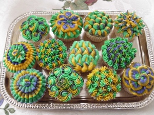 These cupcake icing designs were probably made by: a. a professional, b. a repressed art student, c. someone who's had too much of the Mardi Gras ganja, or d. all of the above.