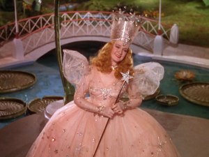 Though there were actually 2 good witches in the L. Frank Baum source material, The Wizard of Oz writers decided to combine the two as Glinda, the Good Witch of the North and played by Billie Burke. Yet, when you watch the movie, this merge tends to have unfortunate implications regarding Glinda.