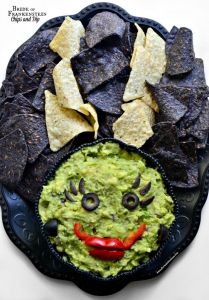 Now the dip is her face and consists of mostly guacamole. And her hair is mostly made from blue and regular tortilla chips. Still, very clever.
