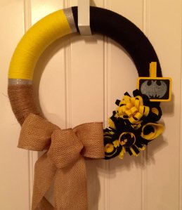 This one seems to contain black and gold ribbons. Take the bat symbol off and it becomes a Pittsburgh Steelers wreath.