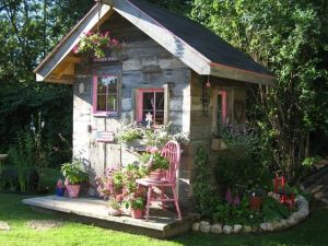 This is rustic enough for a garden. And it has some pink in the windows to stand out and blend with the flowers.