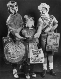 The trick or treat bags are for holding candy. The masks are for scaring the neighbors into giving it to you so they won't have to worry about their lives.